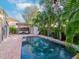 Relaxing pool area with brick patio and tropical landscaping at 3512 W Granada St, Tampa, FL 33629