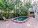 Inviting pool area with brick decking and tropical landscaping at 3512 W Granada St, Tampa, FL 33629