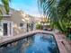 Inviting pool area with brick patio, pergola, and lush landscaping at 3512 W Granada St, Tampa, FL 33629