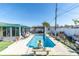 Long rectangular pool in backyard with a gazebo and seating at 444 90Th Ave, St Pete Beach, FL 33706