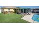 Landscaped backyard with a pool and artificial turf at 444 90Th Ave, St Pete Beach, FL 33706