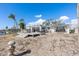 Home exterior showcasing a deck and sandy backyard with water views at 485 41St Ave, St Pete Beach, FL 33706