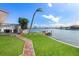 Spacious backyard with a brick pathway leading to the waterfront at 485 41St Ave, St Pete Beach, FL 33706