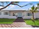 Inviting entryway with light blue door and brick walkway at 485 41St Ave, St Pete Beach, FL 33706
