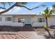 Front view of the house, showcasing its curb appeal and light blue door at 485 41St Ave, St Pete Beach, FL 33706