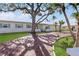 Single story home with a large oak tree and brick driveway at 485 41St Ave, St Pete Beach, FL 33706