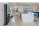 White kitchen with large island, stainless steel appliances, and terrazzo flooring at 485 41St Ave, St Pete Beach, FL 33706
