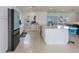 Modern kitchen with white cabinets, quartz countertops and a teal refrigerator at 485 41St Ave, St Pete Beach, FL 33706