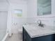 Updated bathroom with a marble countertop vanity and a white subway tile shower at 215 35Th Ne Ave, St Petersburg, FL 33704