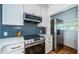 Modern kitchen with stainless steel appliances and blue herringbone tile backsplash at 215 35Th Ne Ave, St Petersburg, FL 33704