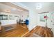 Open living room with hardwood floors, a blue sofa, and a view of the kitchen at 215 35Th Ne Ave, St Petersburg, FL 33704