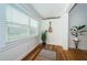 Bright sunroom with hardwood floors, window blinds, and potted plants at 215 35Th Ne Ave, St Petersburg, FL 33704