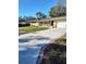 Ranch-style home with a long driveway and mature landscaping at 1182 Norwood Ave, Clearwater, FL 33756