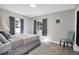 Bedroom with a queen bed, window seating, and a teal accent chair at 463 Park N St, St Petersburg, FL 33710