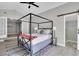 Main bedroom with canopy bed, barn door to bathroom, and wood-look floors at 463 Park N St, St Petersburg, FL 33710