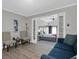 Bright living room with view into spacious bedroom, comfy seating, and wood-look floors at 463 Park N St, St Petersburg, FL 33710