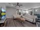 Living room featuring a modern design with an open floor plan and a ceiling fan at 9921 Pier Point Ter, Parrish, FL 34219