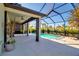 Relaxing pool and patio area with a covered lanai and lush landscaping at 9921 Pier Point Ter, Parrish, FL 34219