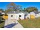 Newly renovated house with stone exterior, landscaped yard, and driveway at 205 Kingston S St, St Petersburg, FL 33711