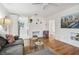 Living room with hardwood floors, fireplace, and comfy seating at 205 Kingston S St, St Petersburg, FL 33711