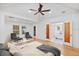 Open bedroom features seating area and a view into the bathroom with soaking tub at 2410 Woodlawn E Cir, St Petersburg, FL 33704