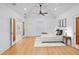 Spacious bedroom features hardwood floors, ceiling fan, and a walk-in glass shower at 2410 Woodlawn E Cir, St Petersburg, FL 33704