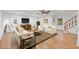 Bright living room with hardwood floors, fireplace, ceiling fan, and comfortable seating at 2410 Woodlawn E Cir, St Petersburg, FL 33704