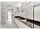 Double vanity bathroom with marble countertops and shower at 11305 Sweet Bay Ct, Riverview, FL 33569