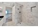 Modern bathroom with a large walk-in shower and marble tile at 11305 Sweet Bay Ct, Riverview, FL 33569