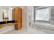 Bathroom with a vanity, soaking tub, and access to another room at 11305 Sweet Bay Ct, Riverview, FL 33569