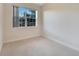 Empty bedroom with carpeted floors and large window at 11305 Sweet Bay Ct, Riverview, FL 33569