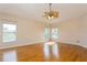 Large bedroom with hardwood floors, ceiling fan, and multiple windows providing natural light at 17929 Timber View St, Tampa, FL 33647