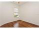 Bright bedroom featuring hardwood floors, white trim, and natural light from the window at 17929 Timber View St, Tampa, FL 33647