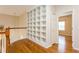 Second story hallway with hardwood floors, white railing, and built-in shelving at 17929 Timber View St, Tampa, FL 33647