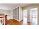 Upstairs hallway with beautiful hardwood floors, white railing, and built-in shelving at 17929 Timber View St, Tampa, FL 33647