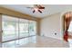 Bright living room with tile flooring and sliding glass doors to a screened lanai overlooking a lake at 17929 Timber View St, Tampa, FL 33647