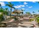Community pool with patio table and grill at 2691 Woodette Dr # D, Dunedin, FL 34698