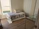 Cozy bedroom with a double bed, large window and glass-top desk at 4993 Bostonian Loop # 4993, New Port Richey, FL 34655