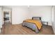 Well-lit bedroom with wood-look floors and access to bathroom at 4993 Bostonian Loop # 4993, New Port Richey, FL 34655