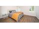 Bright bedroom with wood-look floors and an ensuite bathroom at 4993 Bostonian Loop # 4993, New Port Richey, FL 34655
