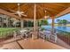 Relaxing gazebo with tables, chairs, and ceiling fans overlooks a pond at 4993 Bostonian Loop # 4993, New Port Richey, FL 34655