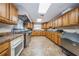 Large community kitchen with wood cabinets and appliances at 4993 Bostonian Loop # 4993, New Port Richey, FL 34655