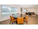 Modern dining room with round table and orange chairs at 4993 Bostonian Loop # 4993, New Port Richey, FL 34655