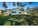 Rear view of house showcasing a well-maintained lawn at 4993 Bostonian Loop # 4993, New Port Richey, FL 34655