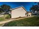 Tan house exterior with large window and grassy yard at 4993 Bostonian Loop # 4993, New Port Richey, FL 34655