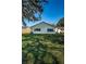 Rear view of house showcasing a well-maintained lawn at 4993 Bostonian Loop # 4993, New Port Richey, FL 34655