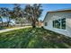 Tan house exterior with large windows and grassy yard at 4993 Bostonian Loop # 4993, New Port Richey, FL 34655