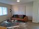 Bright living room with leather sofa and large windows at 4993 Bostonian Loop # 4993, New Port Richey, FL 34655