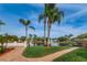 Landscaped waterfront view with palm trees and a walkway at 4993 Bostonian Loop # 4993, New Port Richey, FL 34655