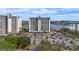 Exterior view of the condos featuring lush trees, parking and stunning waterfront location at 9415 Blind Pass Rd # 905, St Pete Beach, FL 33706